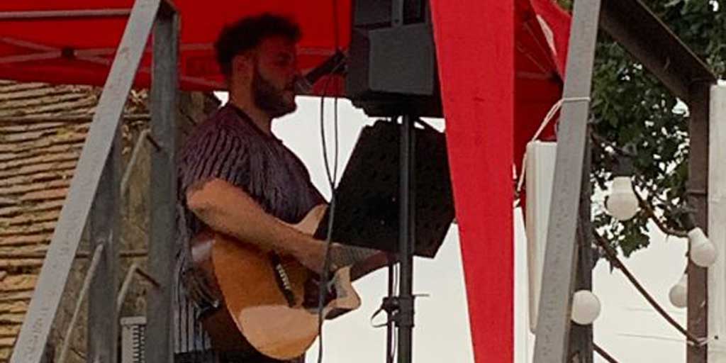 Joe Wheldon playing guitar at a gig