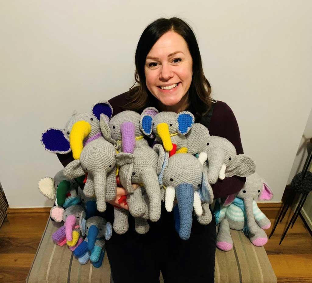 Photo of Sara Matthews and community made elephants