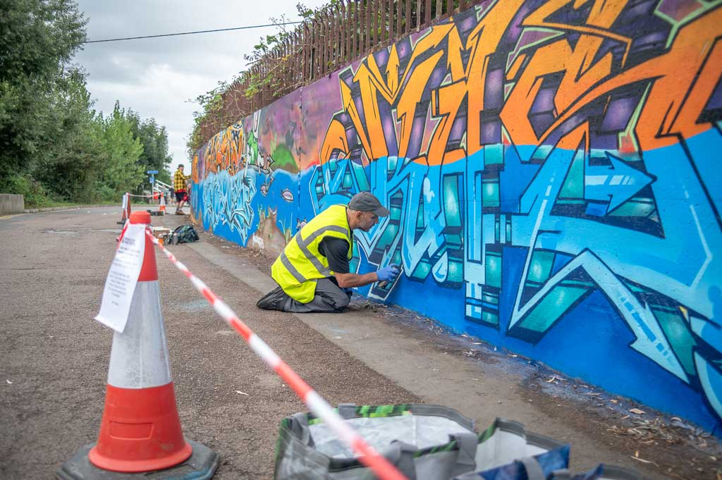 People painting a wall