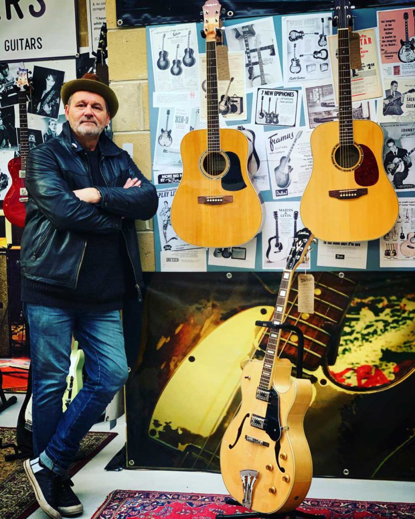 Photo of Paul Thomas with Acoustic Guitars