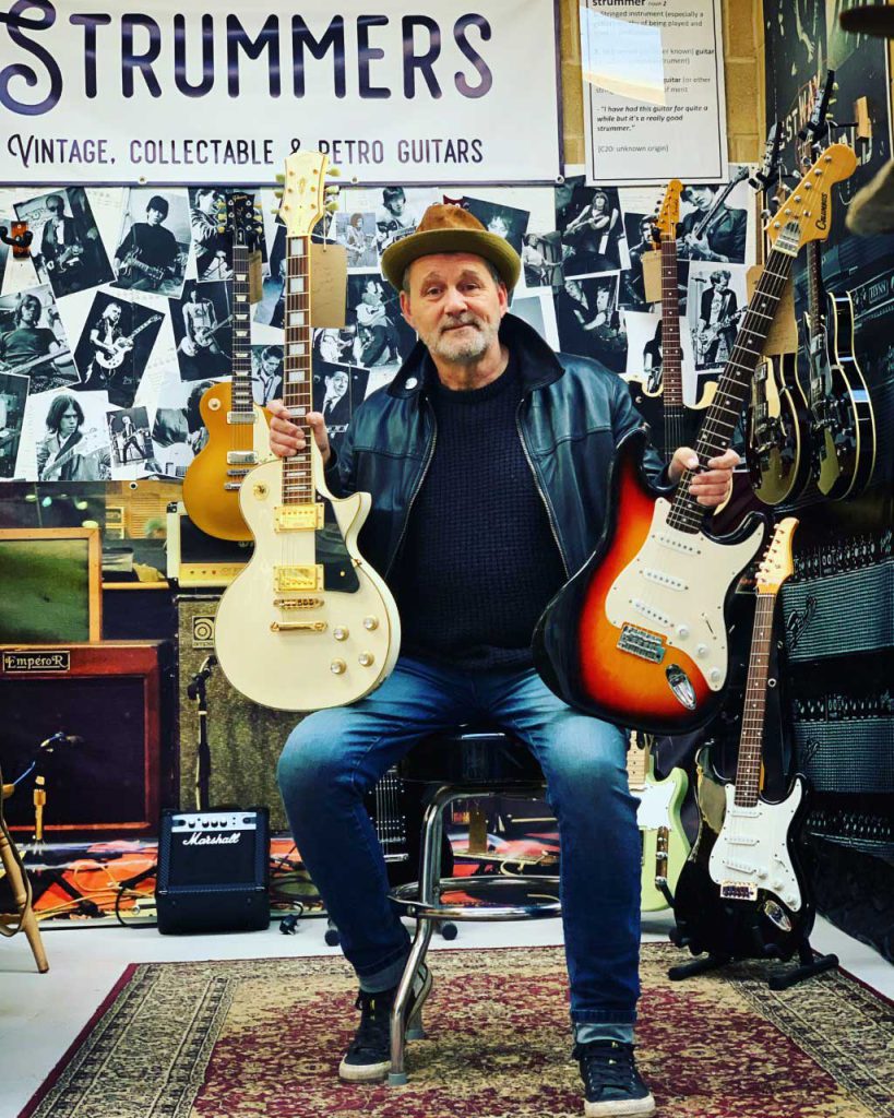 Photo of Paul Thomas with Electric Guitars