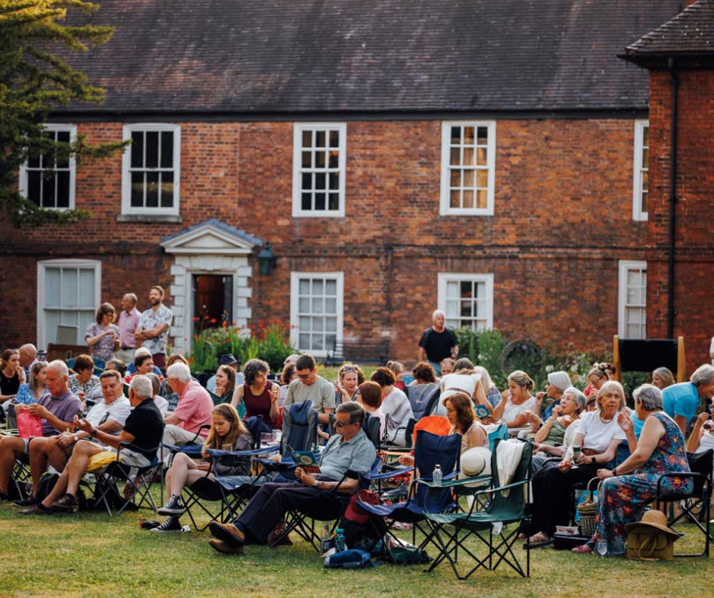 Photo of people sitting outside The Commandery, Worcester