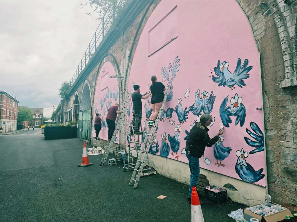 Photo of people painting mural