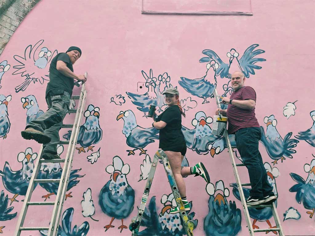 Photo of people painting mural
