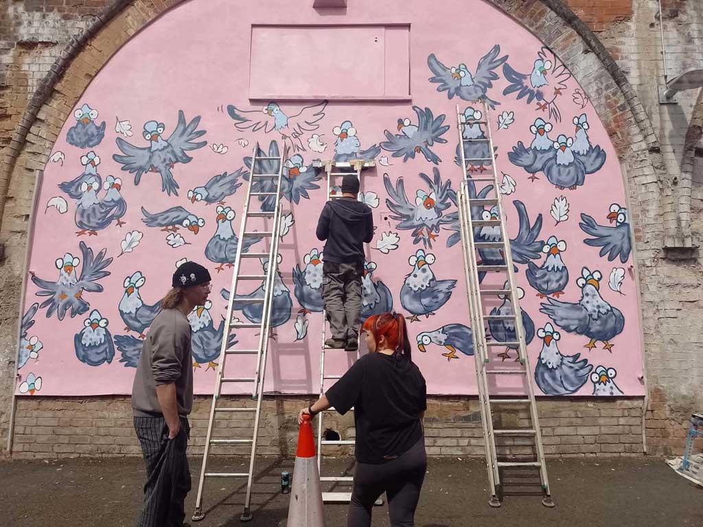 Photo of people painting mural