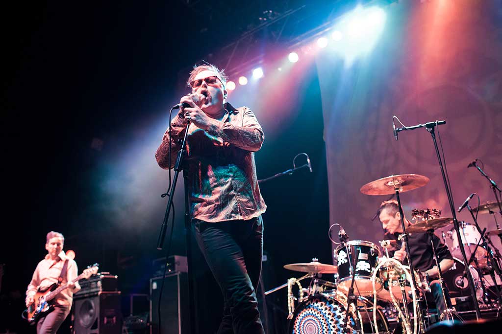 Photo of the band CUD performing on stage