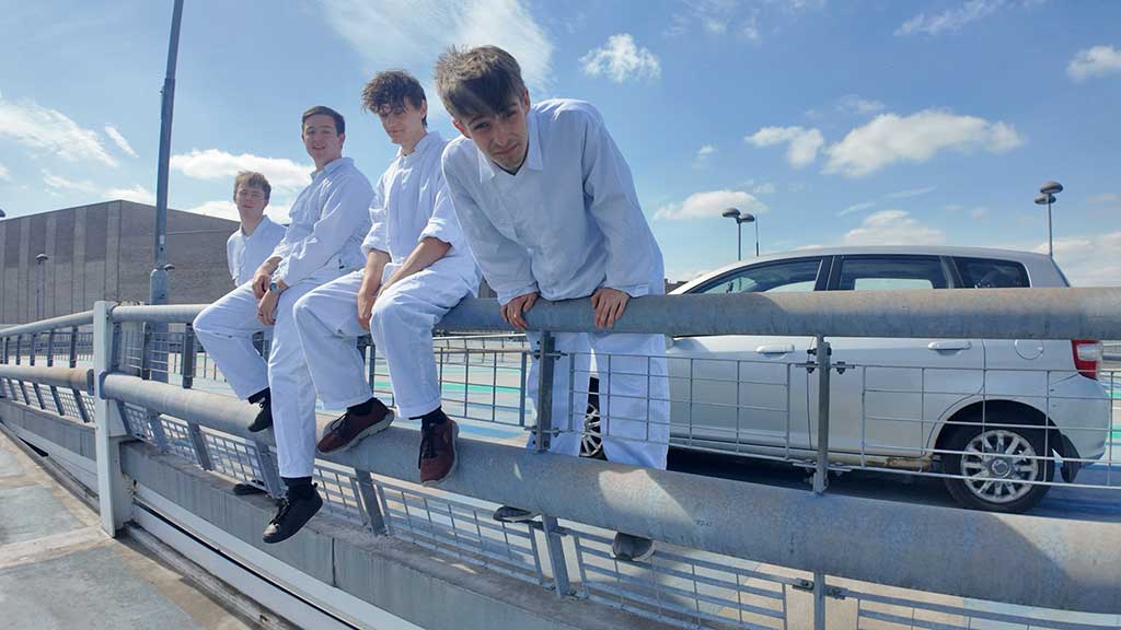 Photo of the band Boomslang on railing