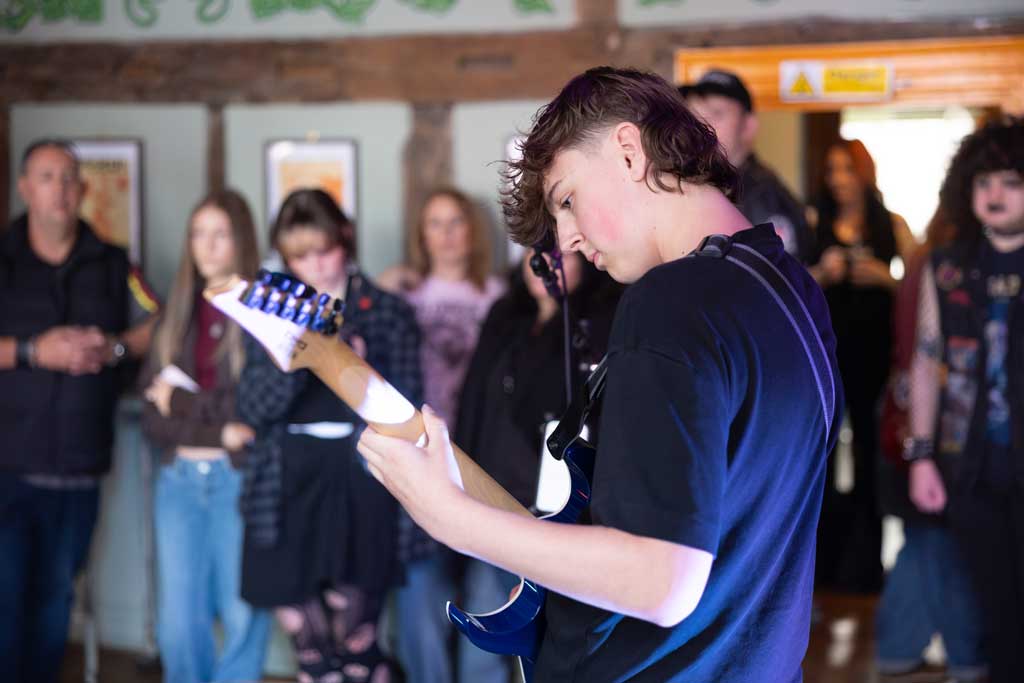 Photo of band the band Deuteronomy and audience