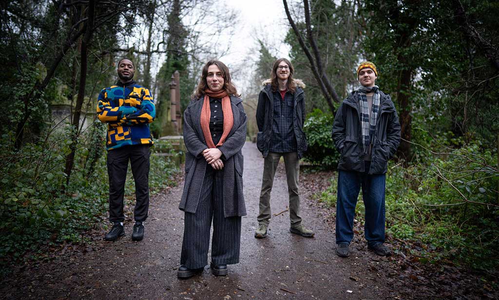 Photo of the band Klara Devlin Quartet standing near trees